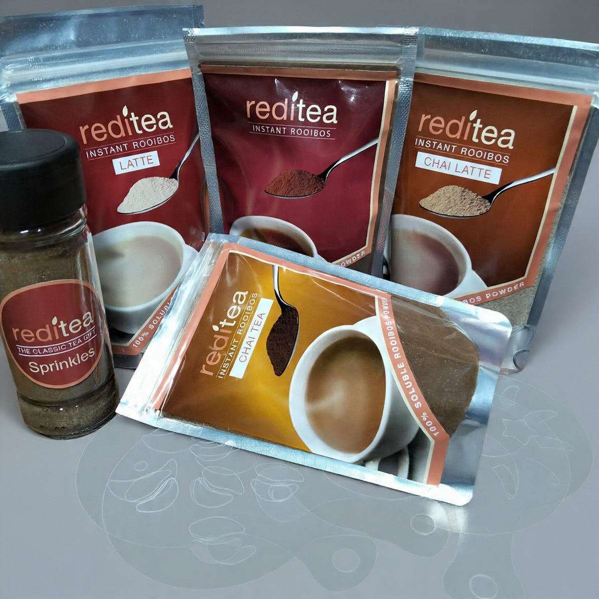 reditea Instant Rooibos bundle includes reditea Latte (200g), reditea Instant Rooibos (125g), reditea Instant Rooibos Chai Latte (120g), reditea Instant Rooibos Chai Tea (80g), reditea sprinkles (80g) and Latte stencils (1 x set of 10)